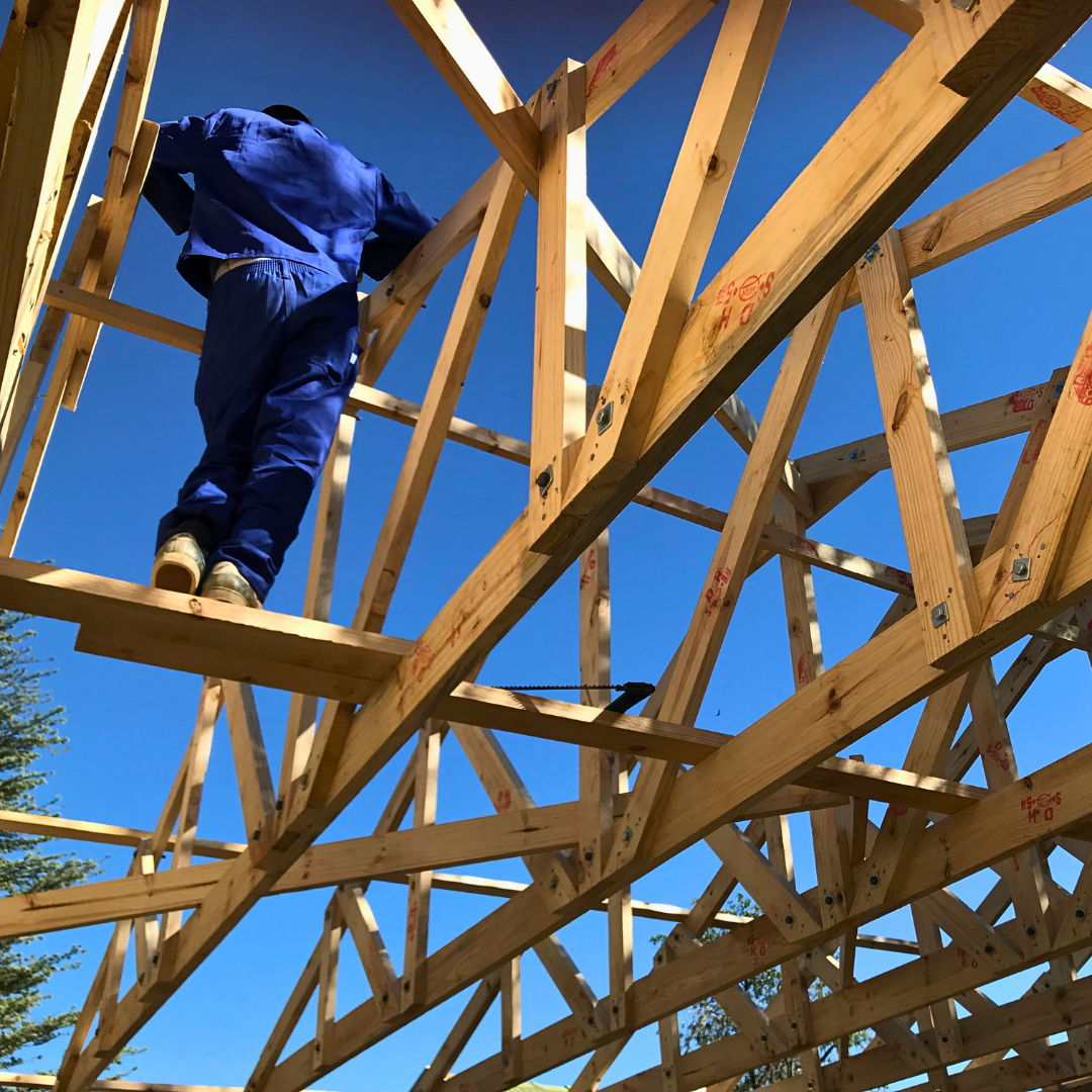 Working on wooden roof trusses during a home renovation in Benoni, South Africa