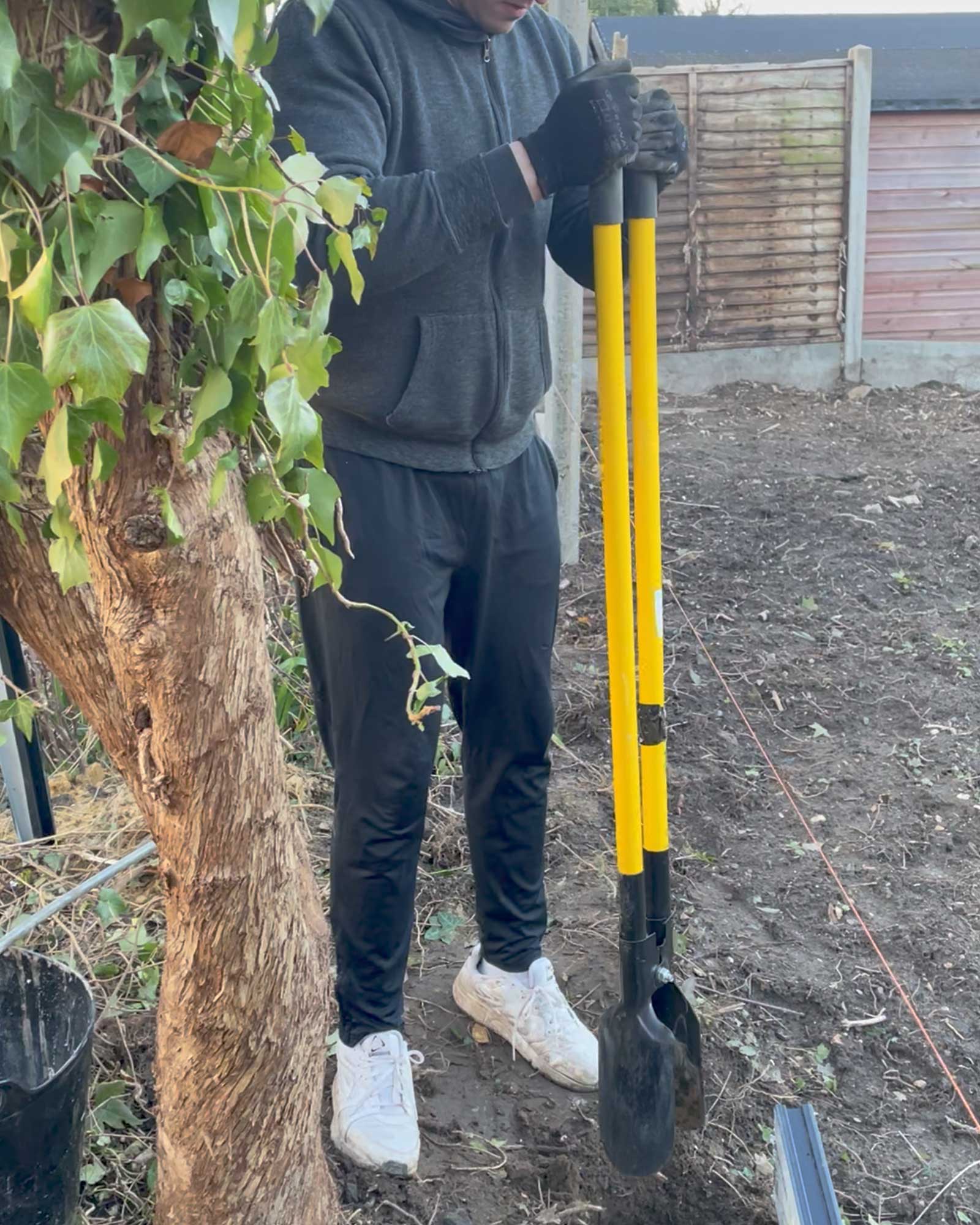 Heavy duty fibreglass fence post hole digger used during the Surrey garden boundary renovation project