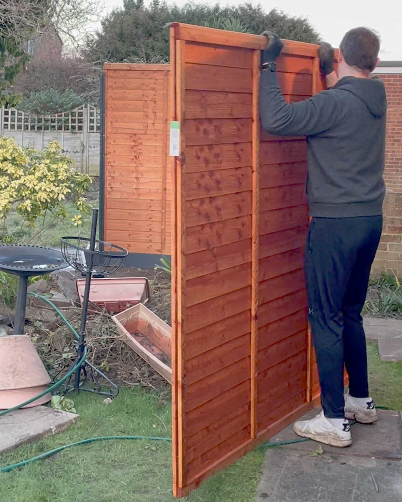 Timber overlap fence panels installed during a family garden renovation project in Surrey