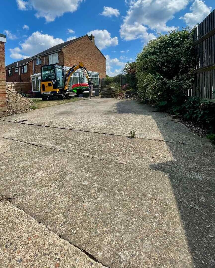 The Driveway That Dominated the Garden Large concrete driveway occupying much of a Surrey family garden before demolition and lawn installation.